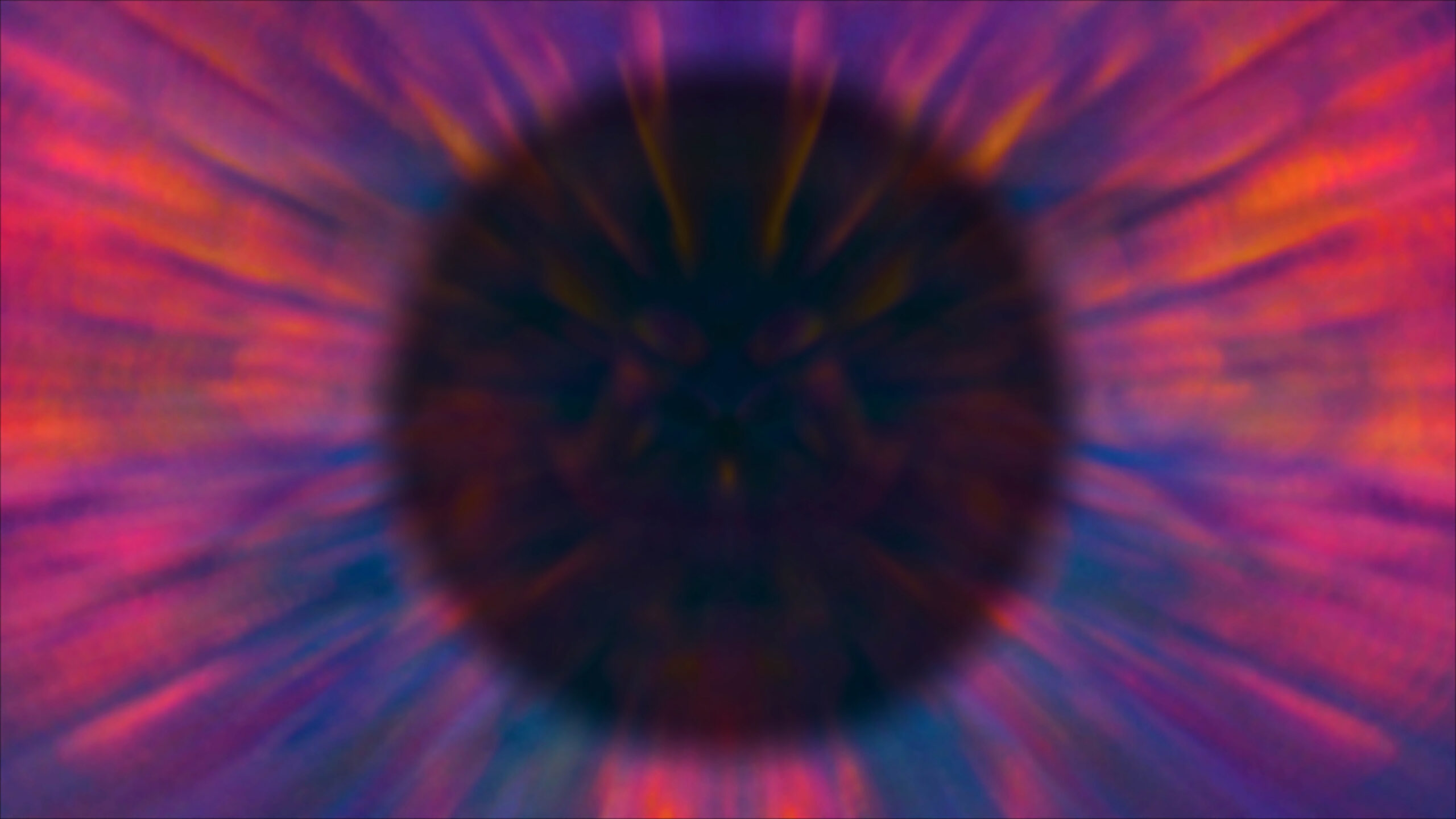 A transparent black circle in the middle of pink and blue psychedelic colurs