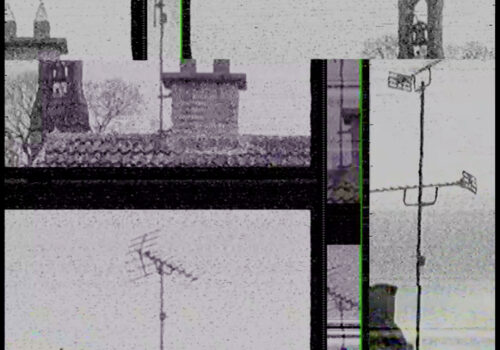A still image from research film material by Frank Sweeney for his forthcoming film called 2 Channel Land. The image mixes together different shots of domestic rooftops with 2 aerials and a church bell tower. The grainy, analogue footage is largely desaturated, with a thin bright green line from the footage’s transmission appearing vertically.