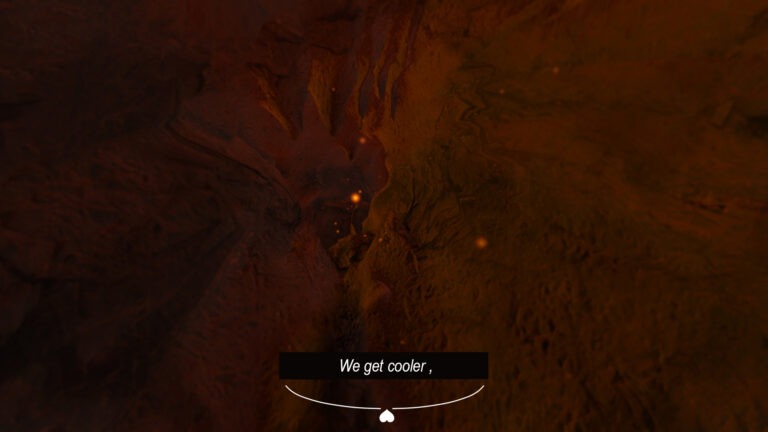 A still from Fault Bound Bodies shows a CG image of the interior of a volcano. The footage is rendered in cartoon-like fashion with brown, rock walls receding into the distance. Light, orange and yellow embers hover across the screen. In the lower half of the screen a black box caption reads ‘We get cooler’ in white, sans serif font. Below the box caption is a small, diagrammatic embellishment showing two white, curved lines positioned side by side with a white, upside down love heart at their centre.