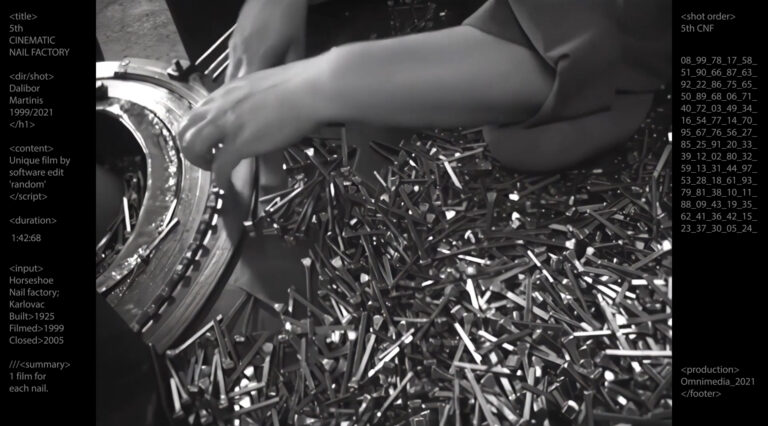 Black and white footage of thousands of nails together within machinery. A person working stretches their arms over the pile