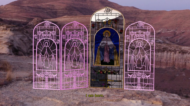 A screenshot from a 3D-modelled animation featuring a series of frames and a stained-glass window all depicting the figure of the Virgin Mary surrounded by various Mackintosh-style decorations. The frames are made using a pink material, and the stained-glass window features a gold frame, and is composed of a wide variety of clear and brightly coloured glass. Both the stained-glass window and pink frames are set against a HDRI background featuring a mountainous terrain. Yellow subtitles, which say, “I am born.”, overlay the foreground of the image.