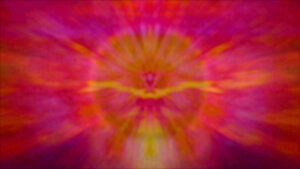 A psychedelic, energetic image of rich yellow colour forming line against the background a fiery ball in bright pink, purple and orange colours