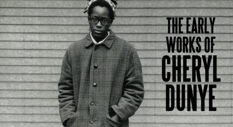 Black and white image of a person with dark skin standing in front of a wall. They are wearing a long buttoned-up coat, with a white shirt collar showing, a hairband, and glasses. There is large black text in all capitals to their left which reads THE EARLY WORKS OF CHERYL DUNYE.